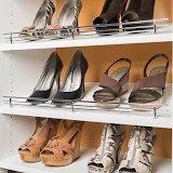 A closet filled with lots of shoes on shelves.