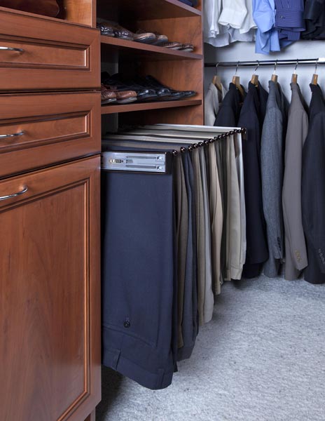 A closet with pants hanging out of a drawer