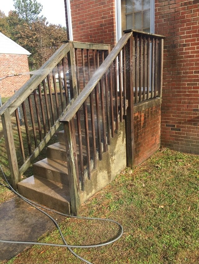 dirty old wood stairs with a bricks wall