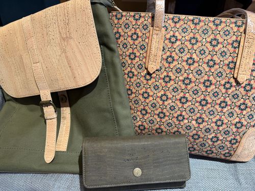 Three small handbags in tan, green, and floral patterns displayed side by side.