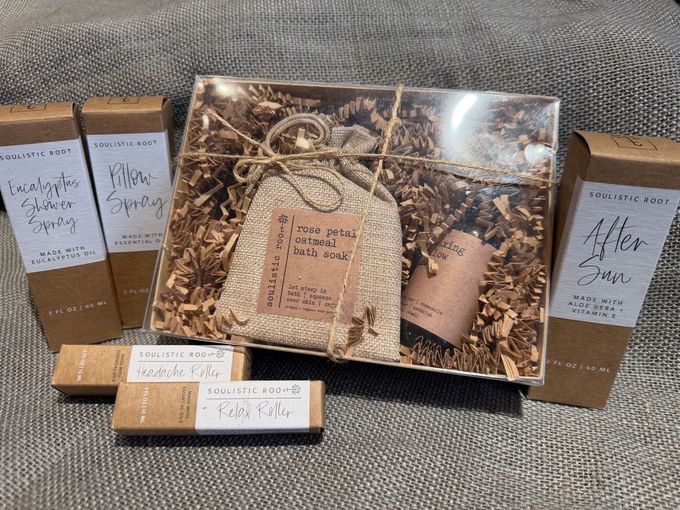 Assorted handmade craft gift boxes and wrapped packages arranged on a gray couch.