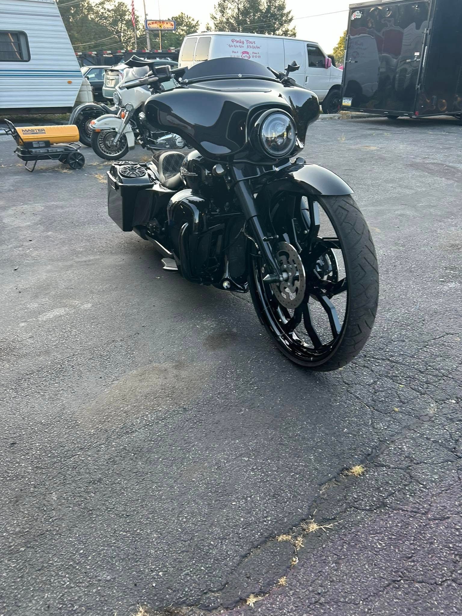 Black custom motorcycle parked on asphalt.