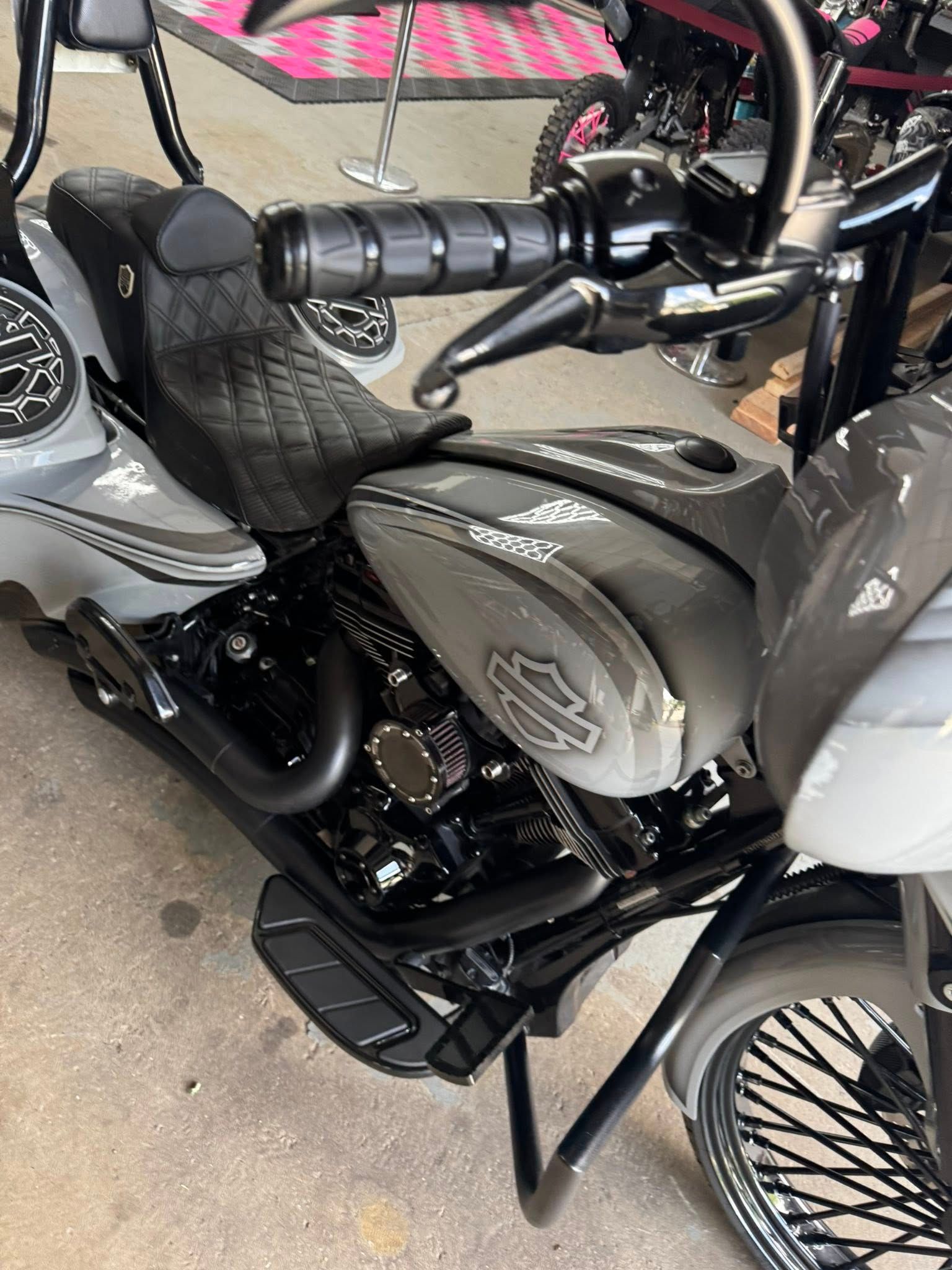 Gray Harley-Davidson motorcycle with black accents; parked outside.