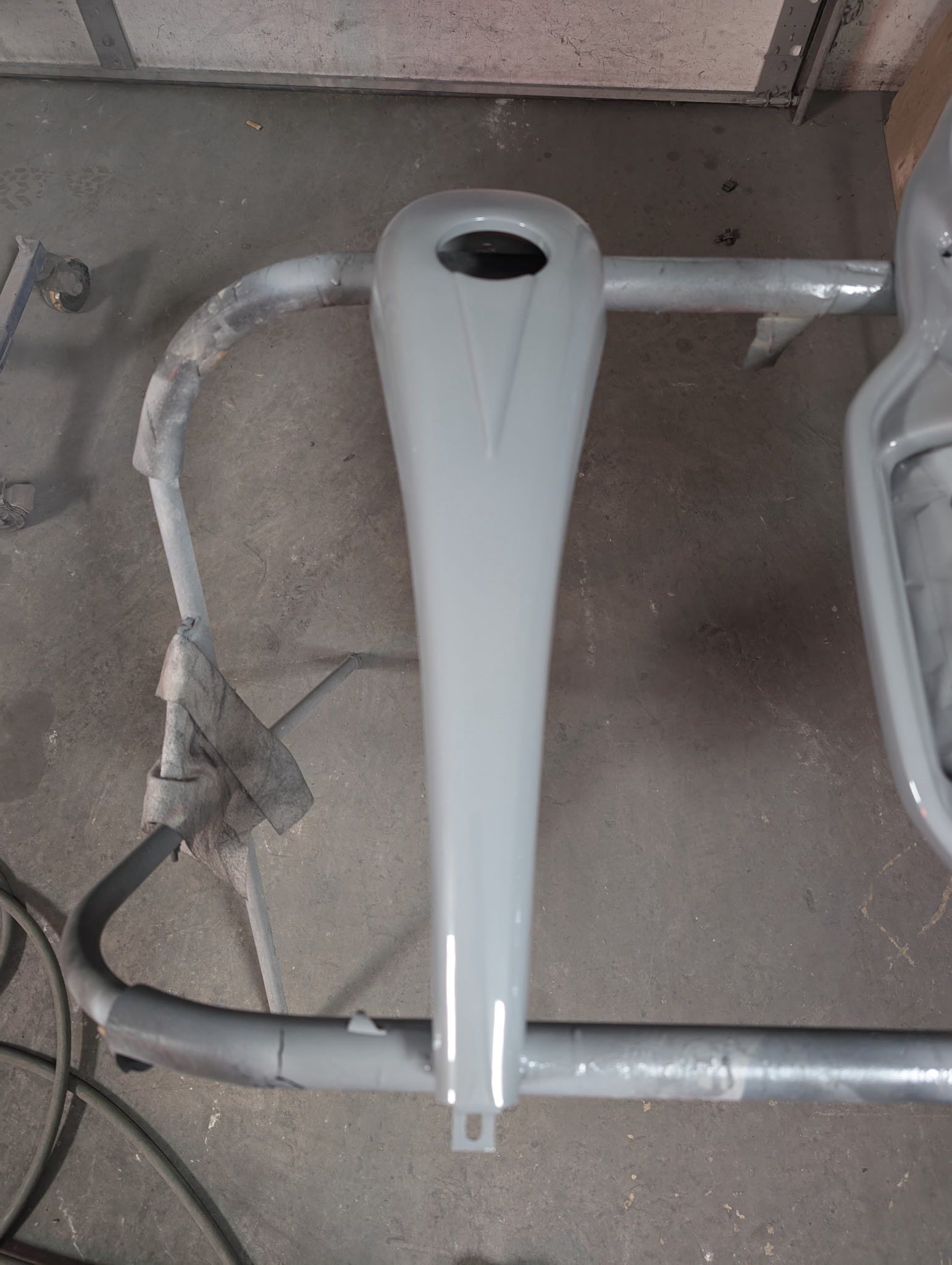 Gray painted vintage scooter body part with a hole on top.