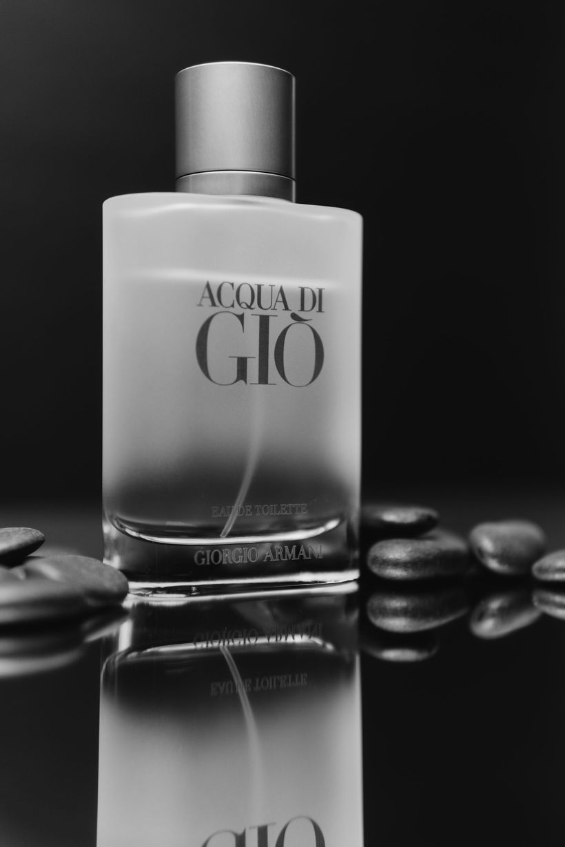 A black and white photo of a bottle of acqua di gio
