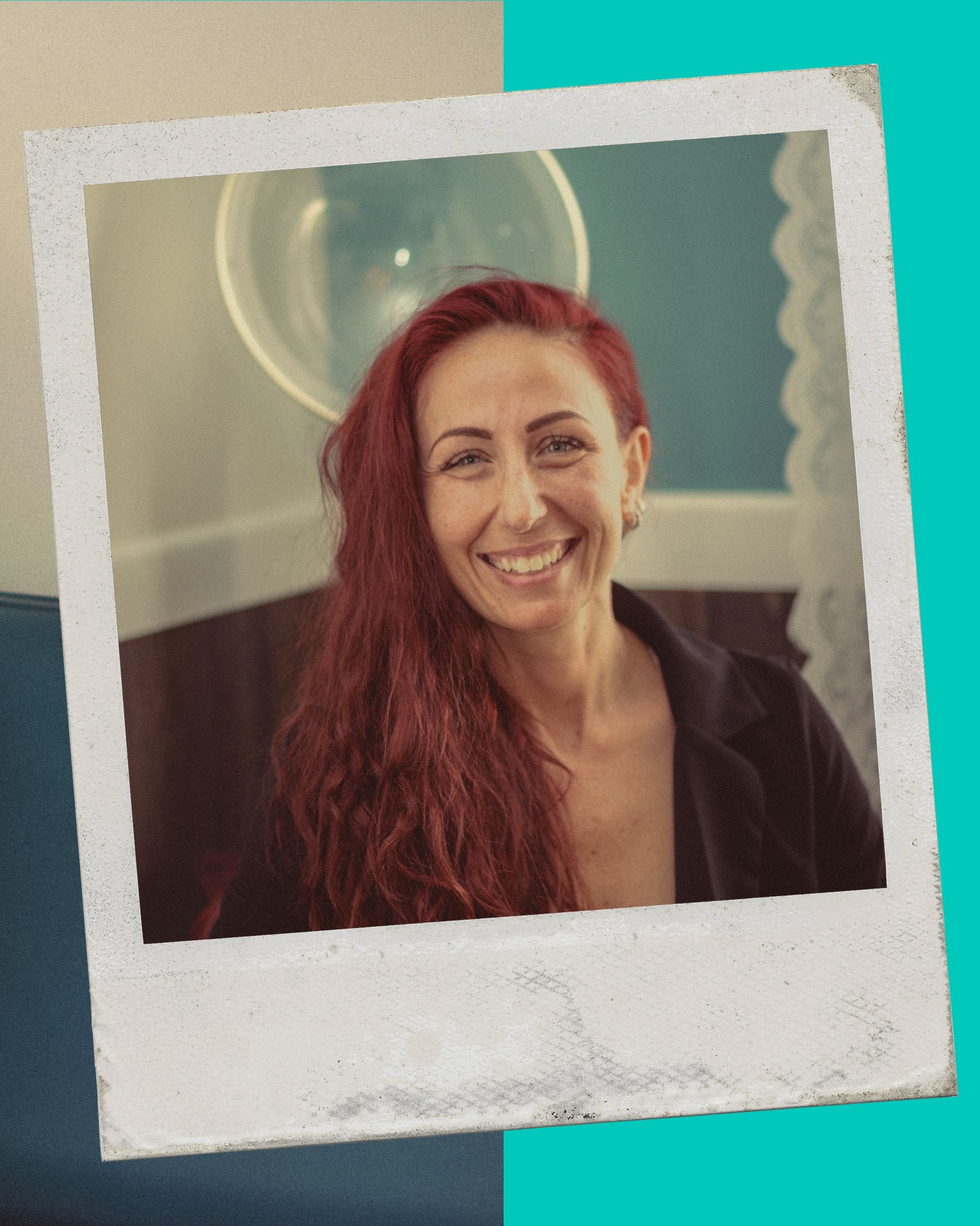 A woman with red hair is smiling in a polaroid frame