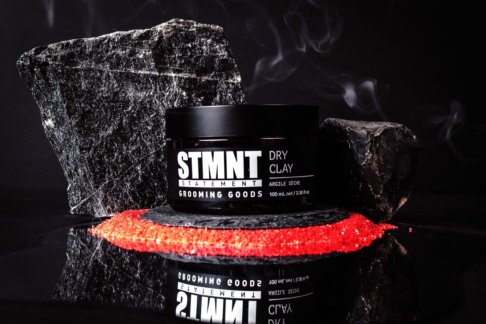 A jar of stmnt dry clay sits on a rock