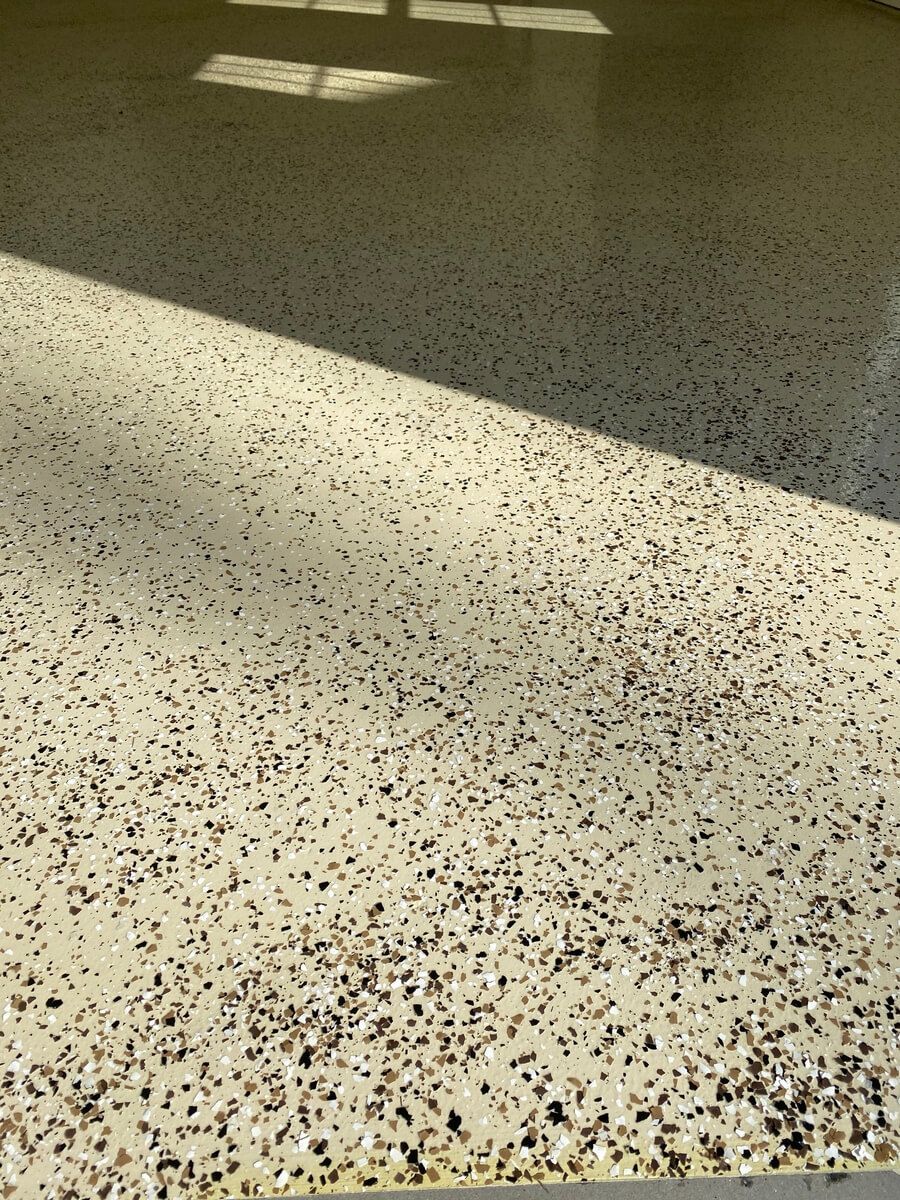 A close up of a concrete floor with a lot of small stones on it.