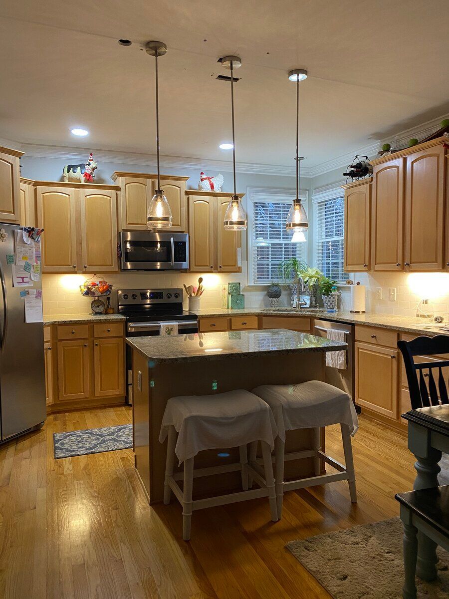 A kitchen with stainless steel appliances and wooden cabinets