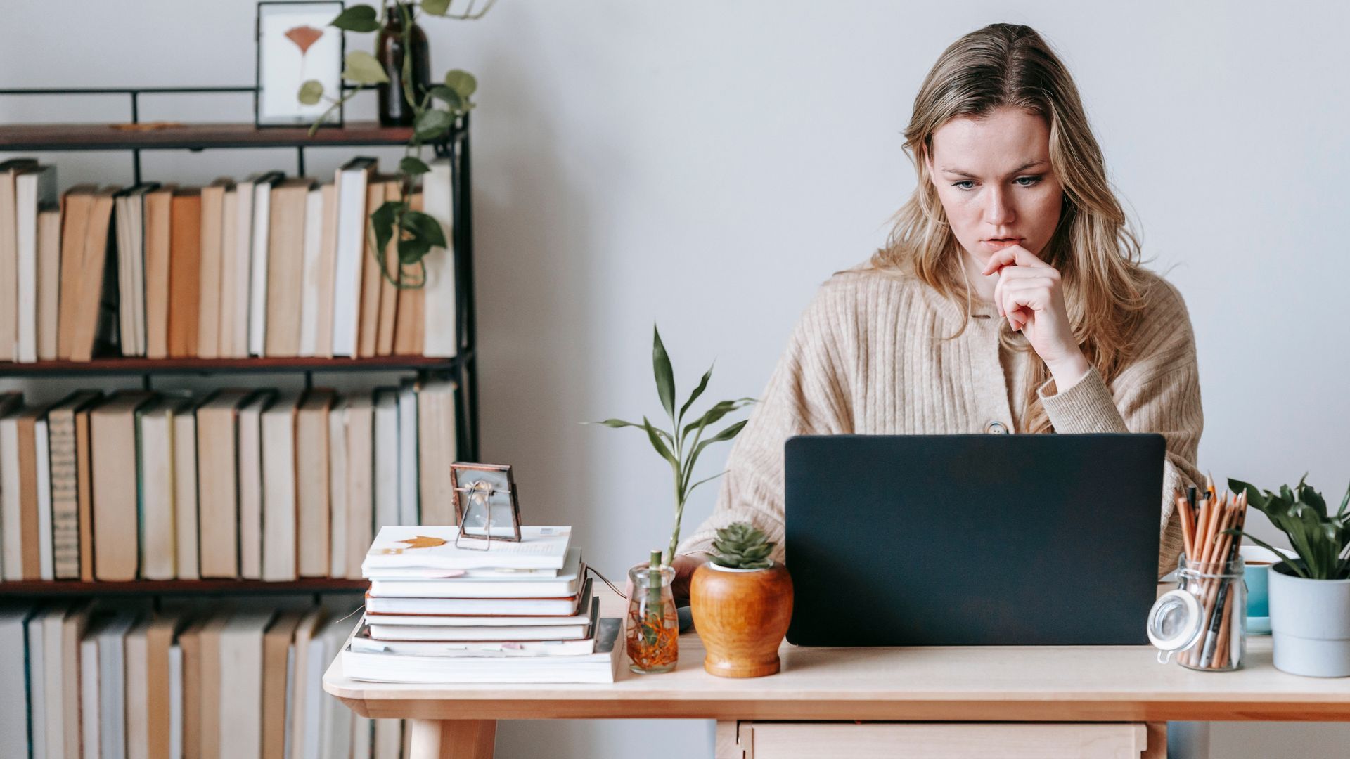 A family is posing for a picture in the grass in front of a lake.
