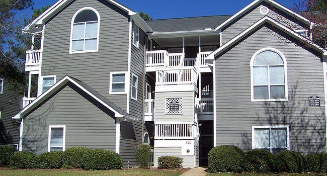 A large apartment building with a lot of windows and balconies.