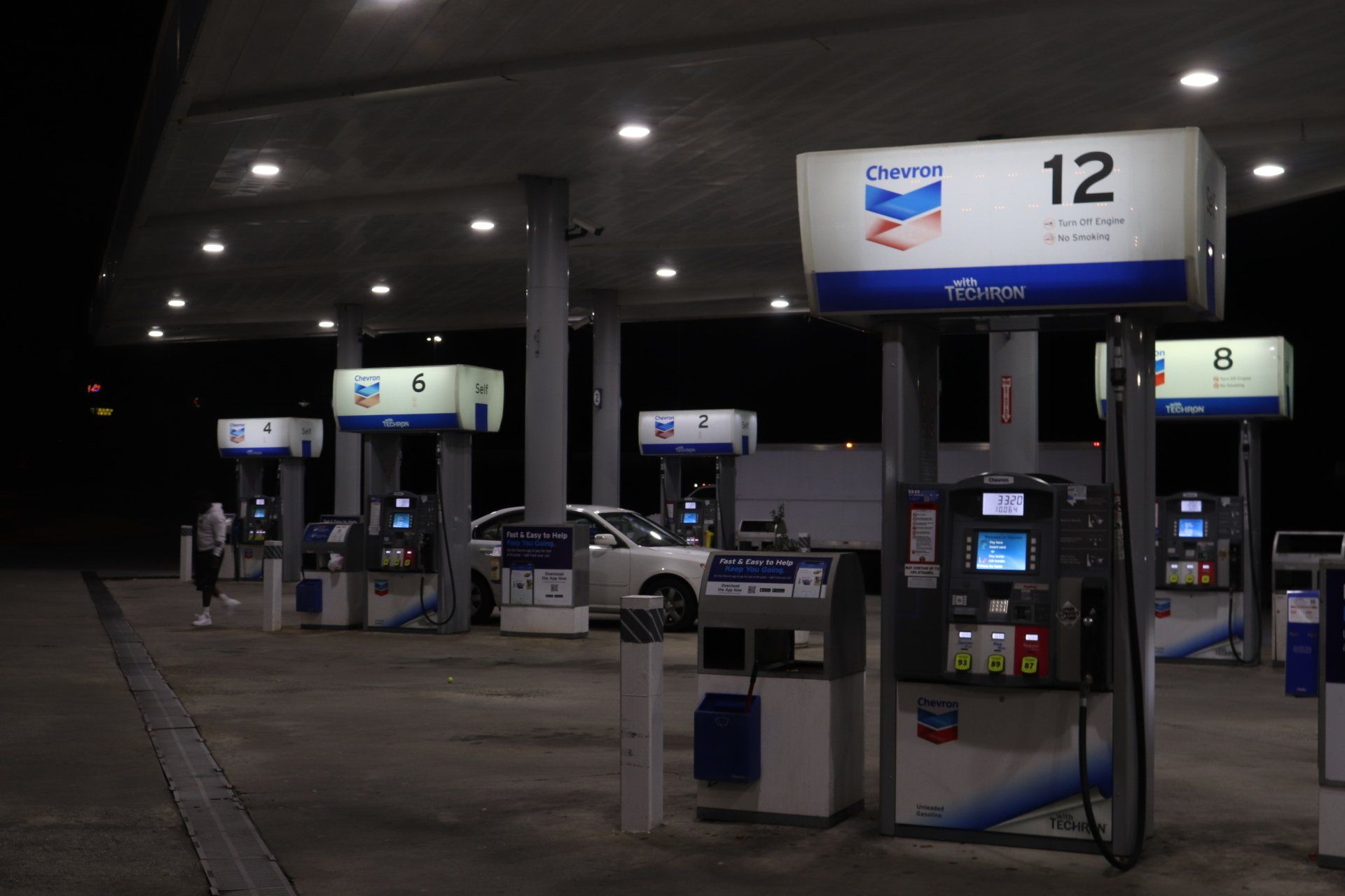 A chevron gas station is lit up at night