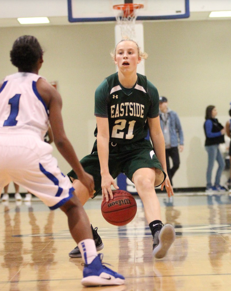 A female basketball player with the number 21 on her jersey