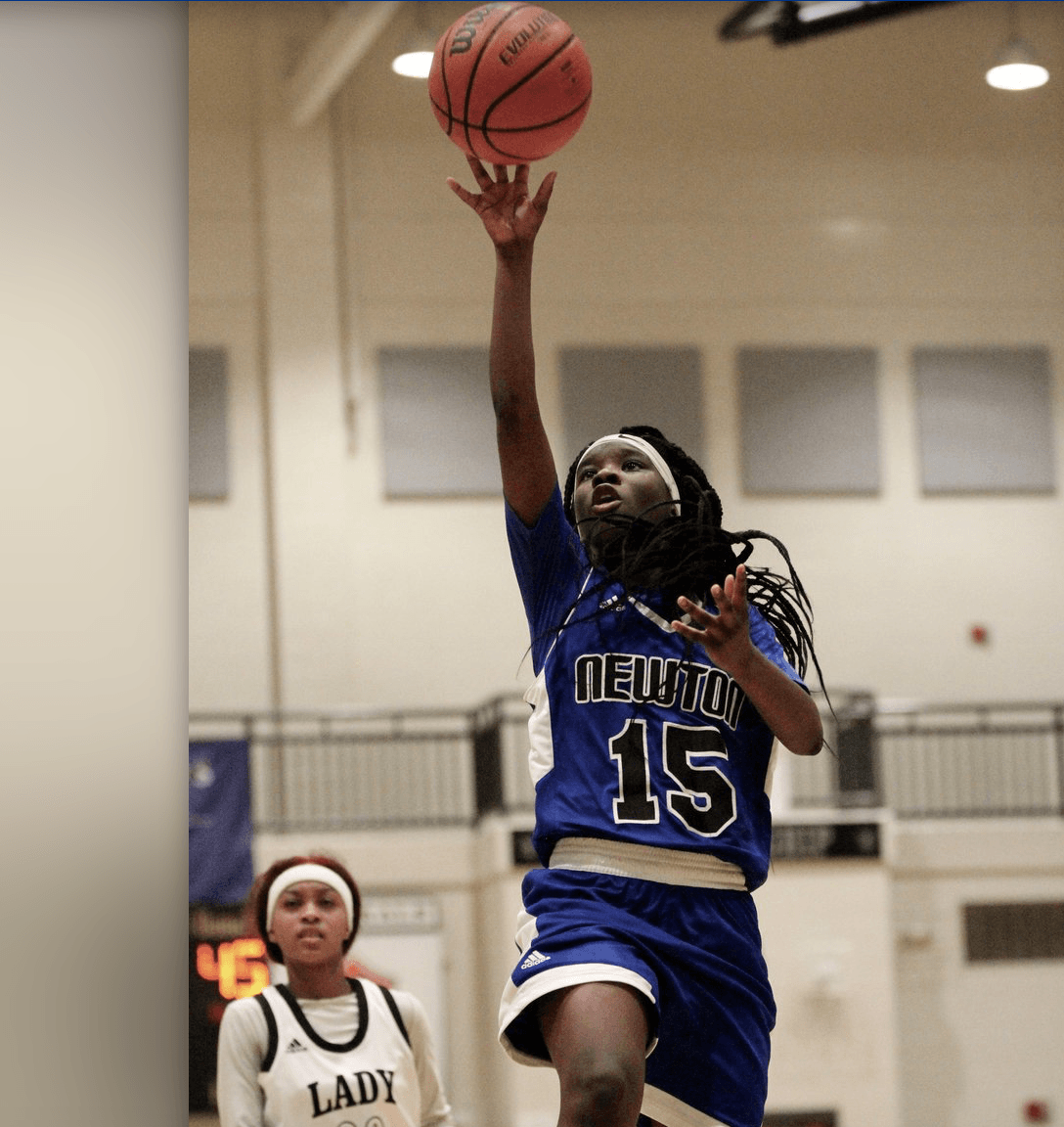 A female basketball player with the number 15 on her jersey