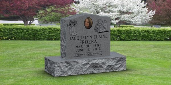 A gravestone in a cemetery with a picture of a child on it.