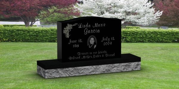 A black gravestone with the name luke marie garcia on it