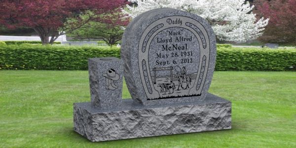 A gravestone in the shape of a horseshoe in a cemetery.