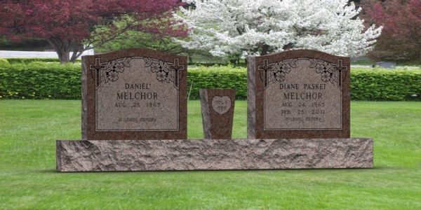 A couple of graves in a cemetery with flowers in the background.