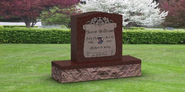 A gravestone in a cemetery with flowers in the background.
