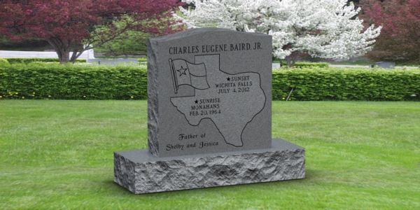 A gravestone in a cemetery with a map of texas on it.