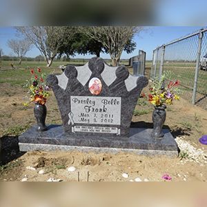 A church filled with rows of black benches and a podium.