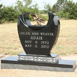 A living room with two chairs a table and a lamp
