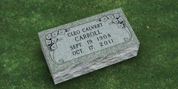 A black gravestone with the name alexander on it