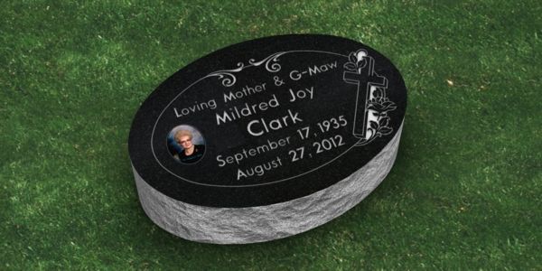 A black gravestone in a cemetery with the name allen on it.