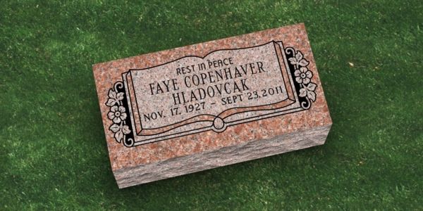 A purple gravestone with the name burton on it is in a cemetery.