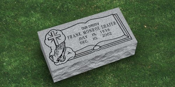 A gravestone for frank monroe shafer is sitting on top of a lush green field.
