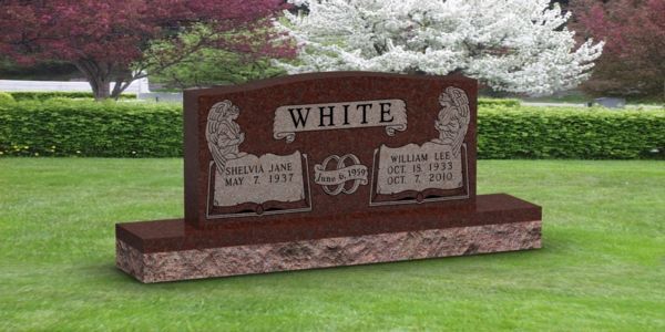 A red gravestone in a cemetery with the name white on it.