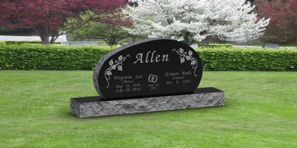 A black gravestone in a cemetery with the name allen on it.