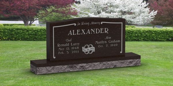 A black gravestone with the name alexander on it