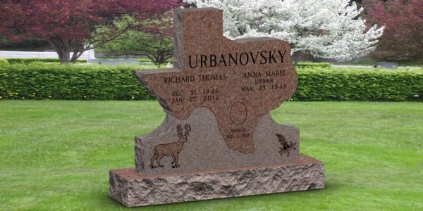 A gravestone in the shape of a texas map in a cemetery.