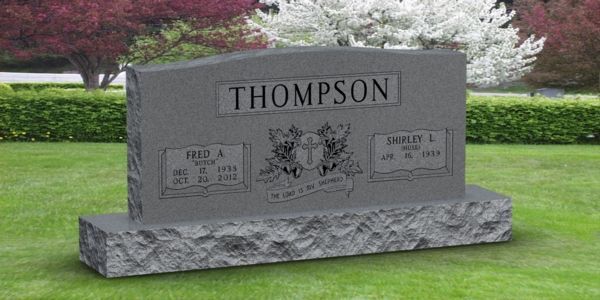 A gravestone in a cemetery with the name thompson on it.