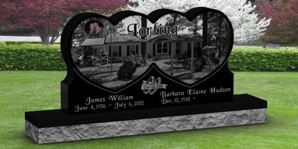 A heart shaped gravestone with a picture of a house on it
