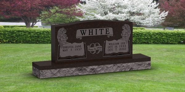 A gravestone in a cemetery with the name white on it.