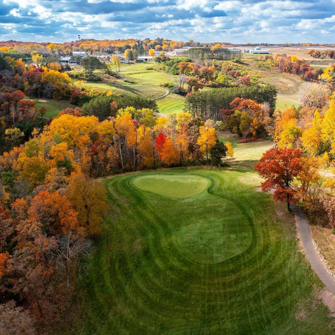 A wooden bridge over a small waterfall in a park