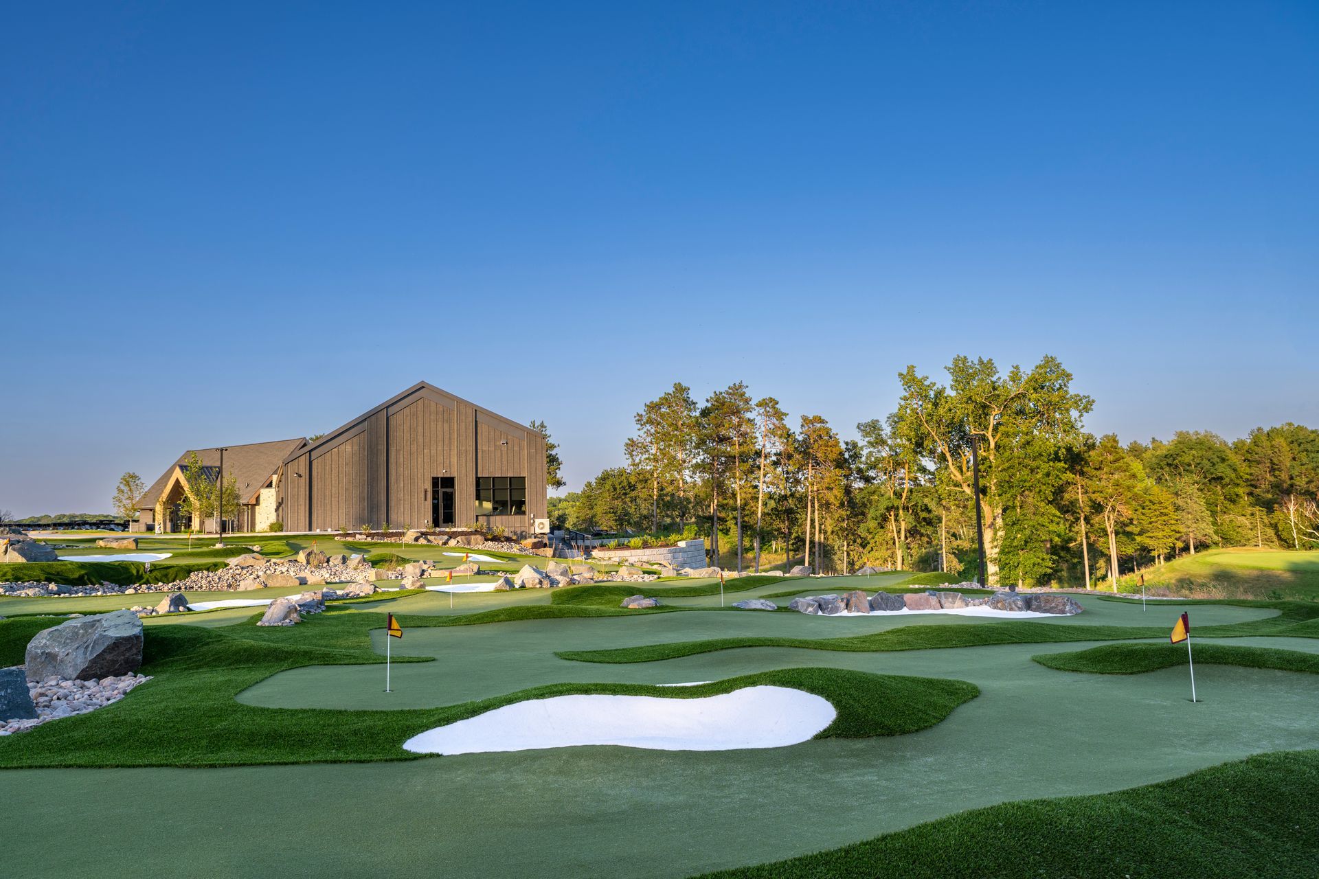 A golf course with a house in the background.