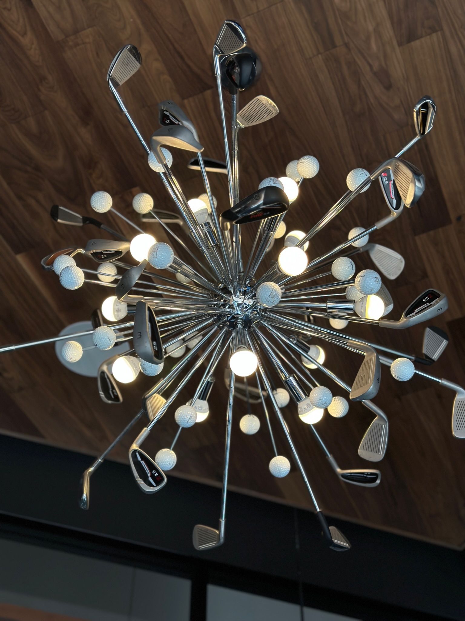 A chandelier made out of golf clubs and balls