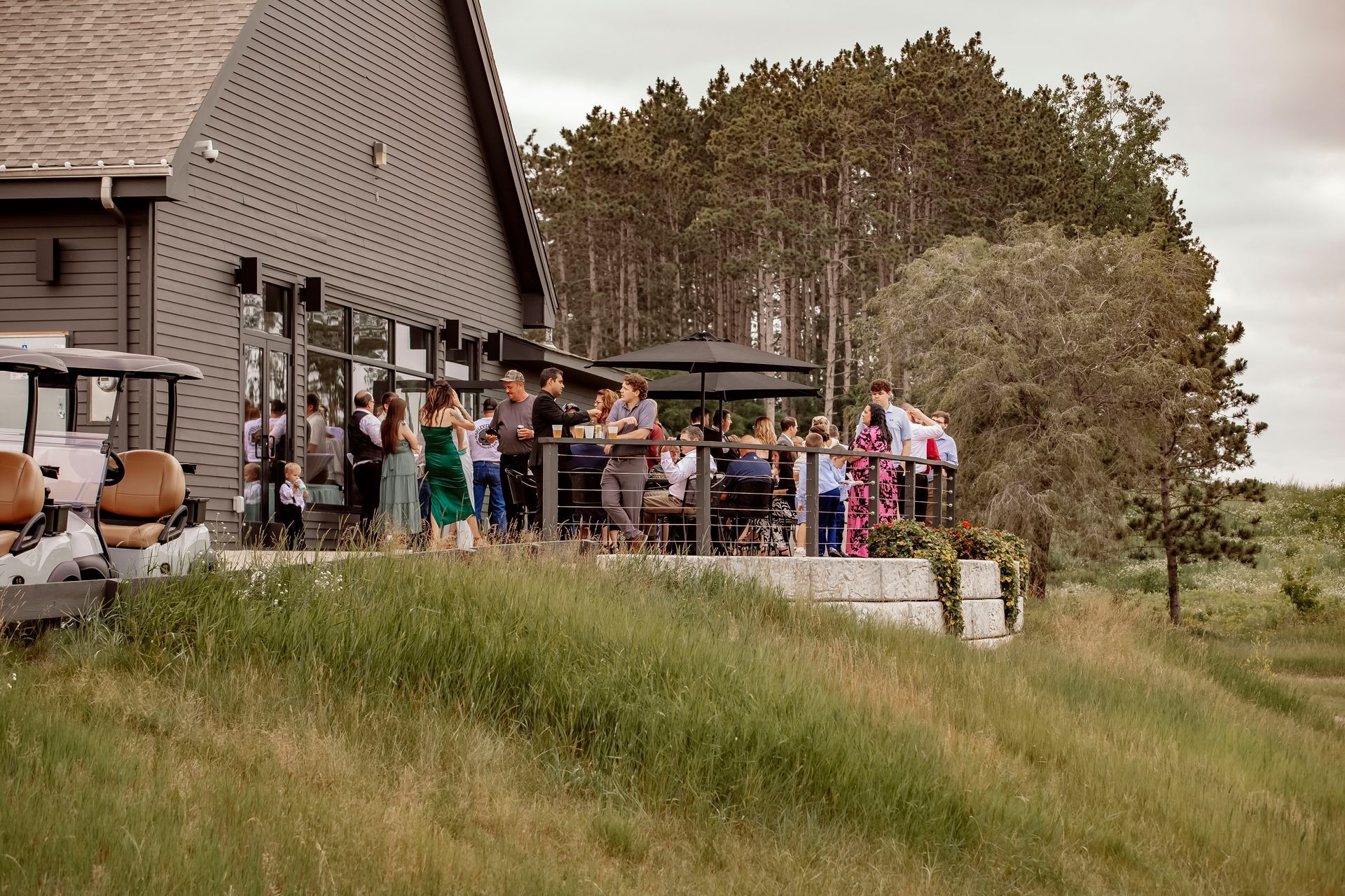 A bride and groom are standing on a wooden bridge.