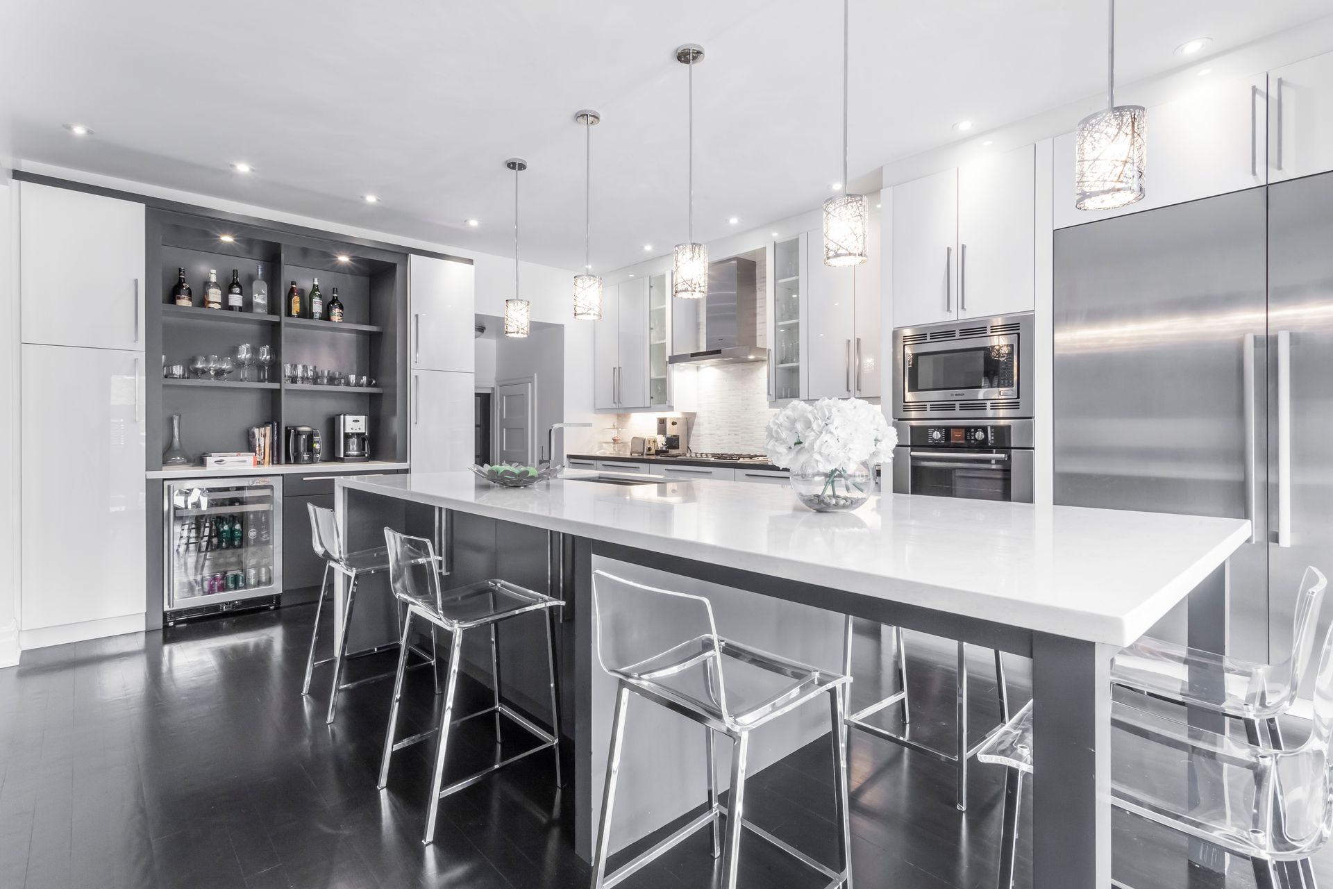 A kitchen with stainless steel appliances and a large island.