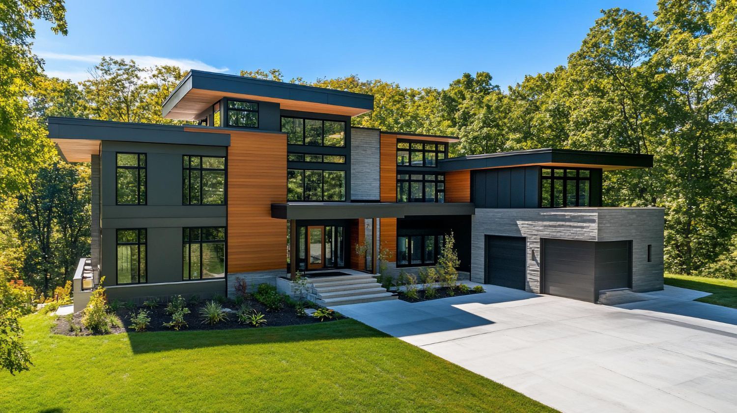 Modern multi-story home with gray and wood siding, large windows, and a two-car garage, set on a green lawn.