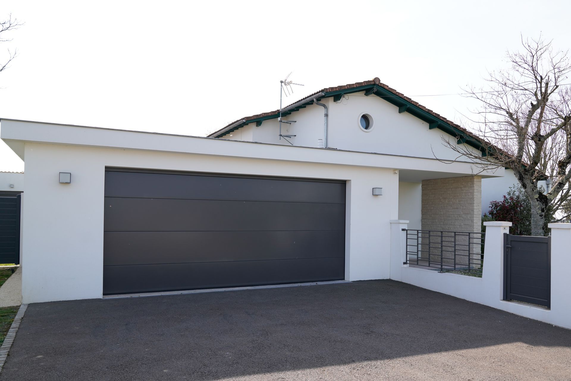 A white house with a black garage door