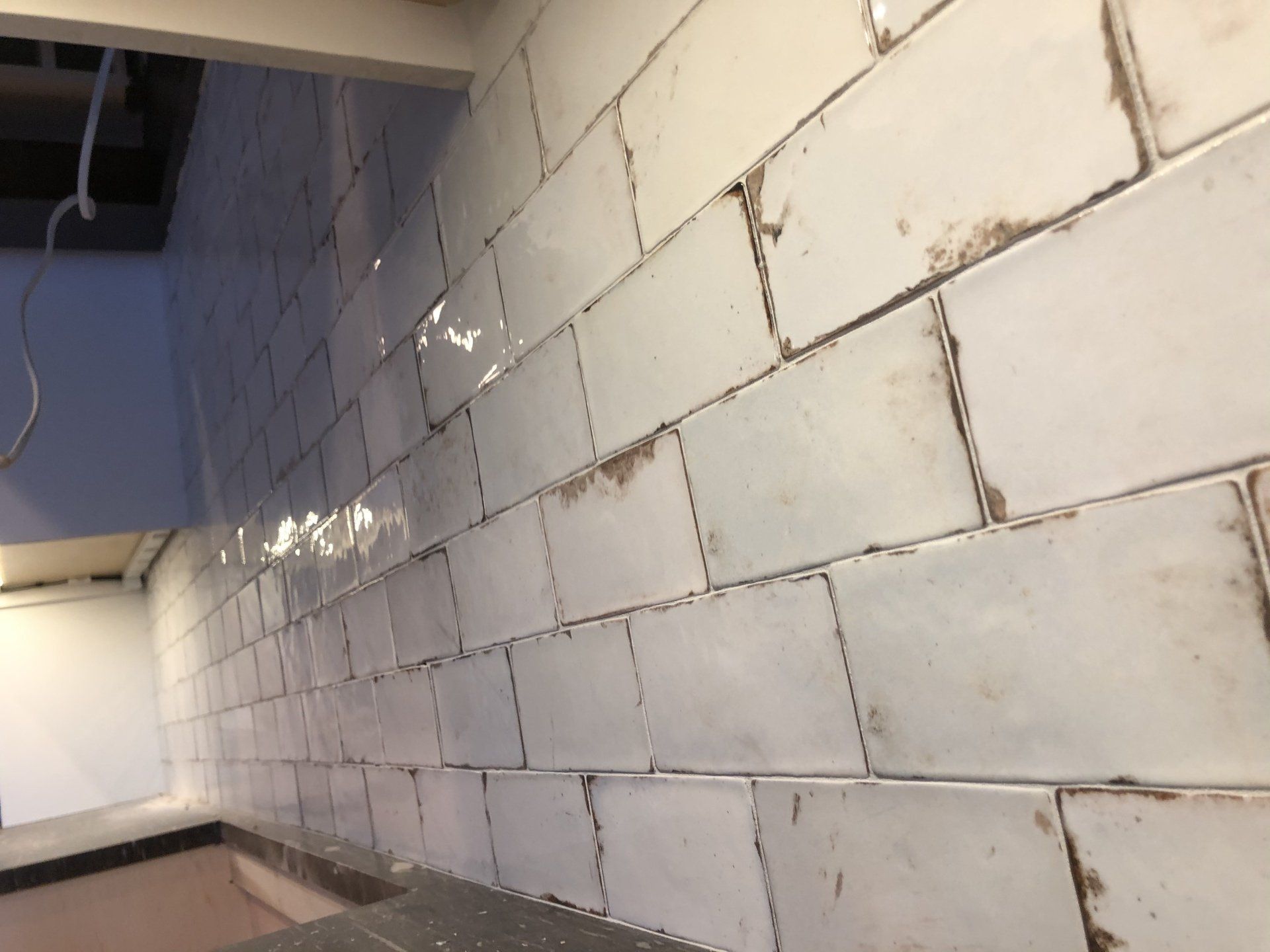 A wall with a lot of white tiles on it