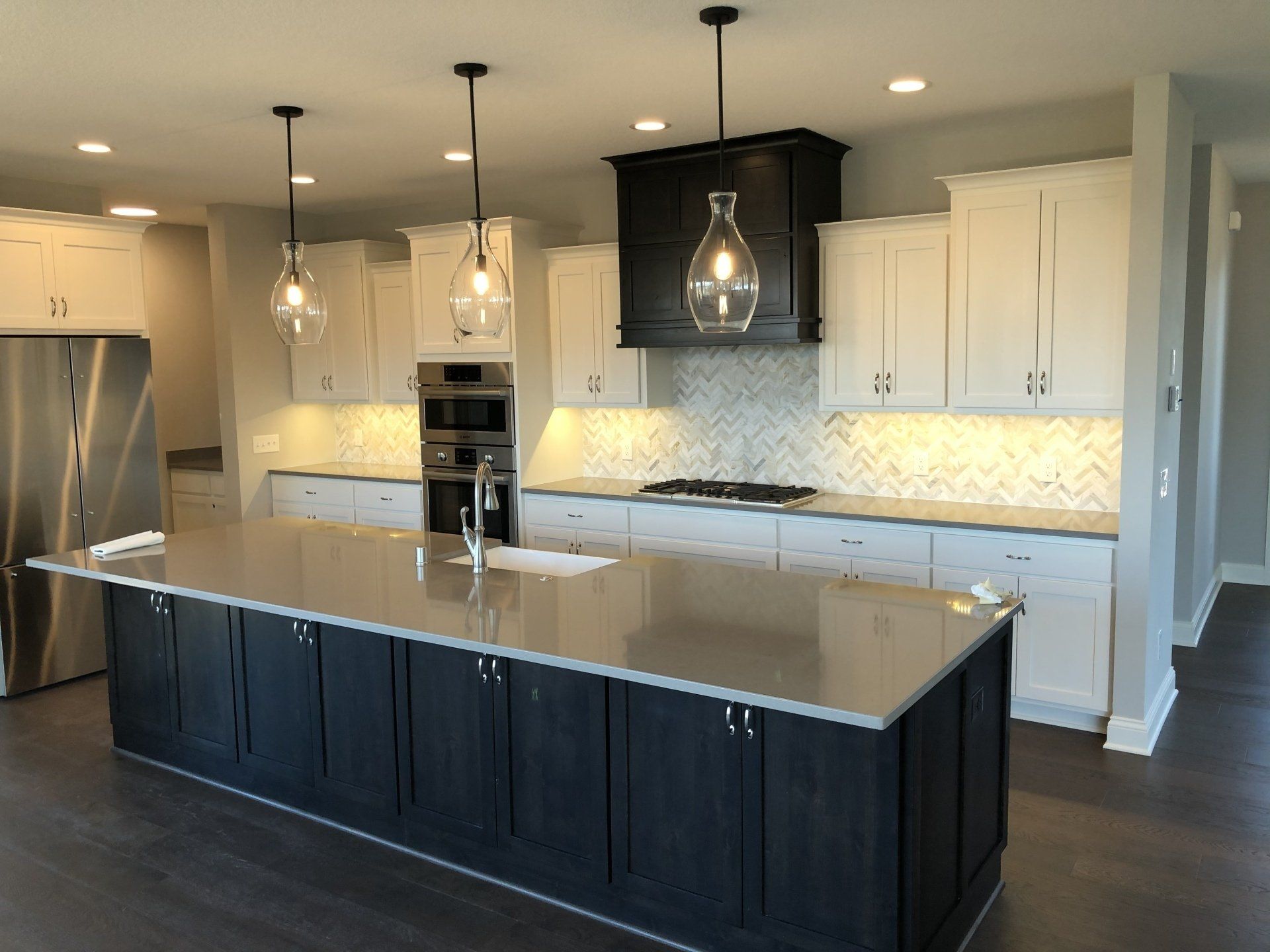 A kitchen renovation with a large island and white cabinets