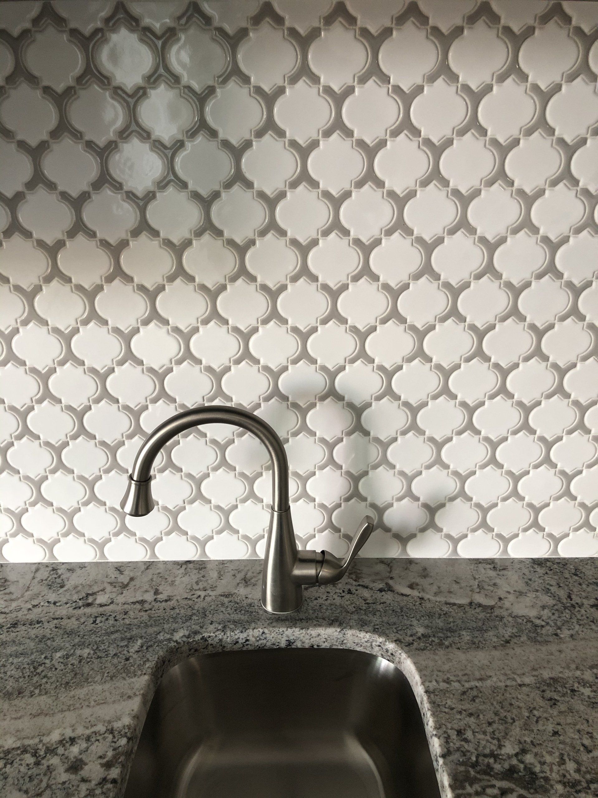 A kitchen backsplash idea with granite counter top.