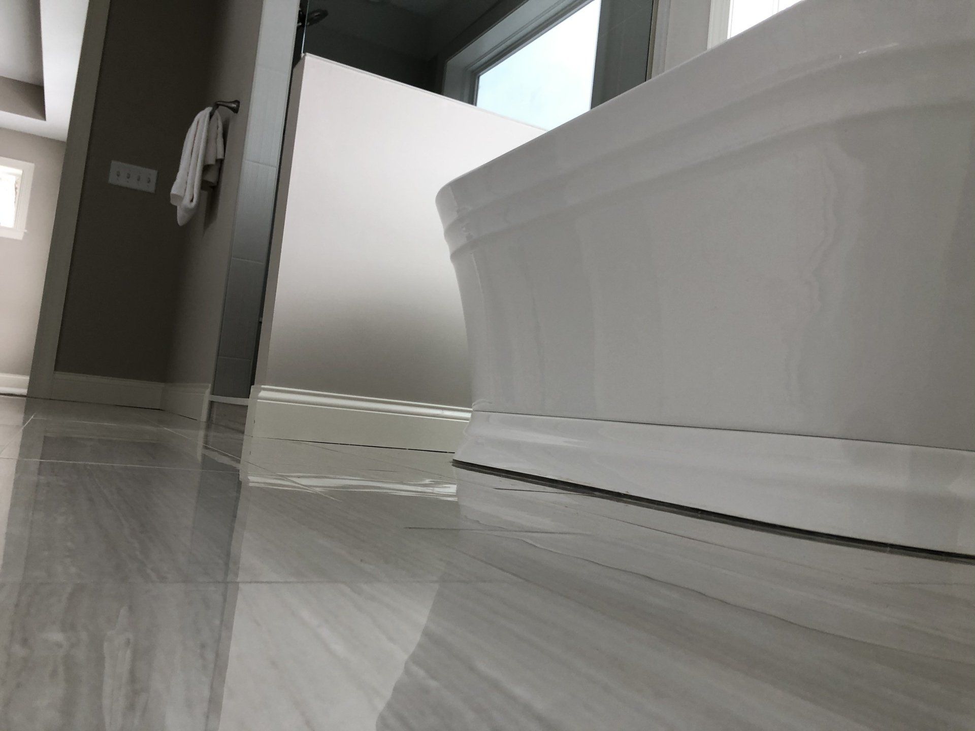 A bathroom reno with a bathtub and a window.