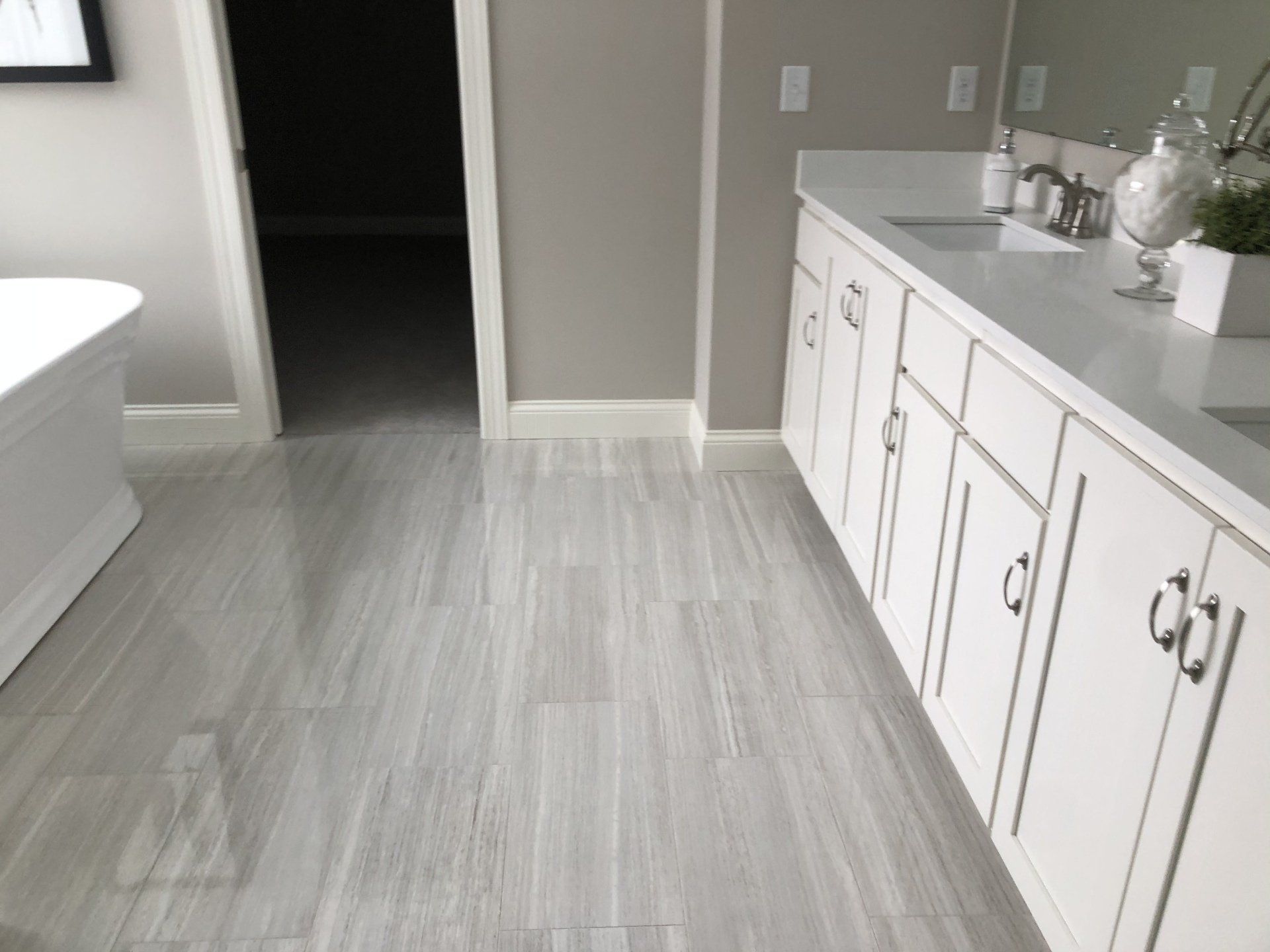A bathroom reconstruction with two sinks and a bathtub.
