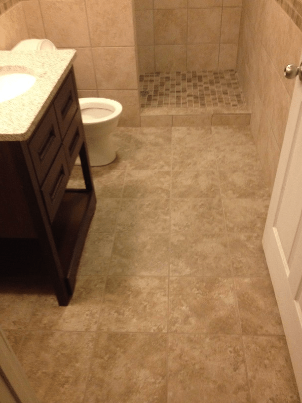 A small bathroom with a toilet , sink and shower